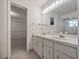 A well-lit bathroom with double sinks and a walk-in shower at 137 Hickory Ridge Cir, Lake Mary, FL 32746