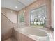 Soaking tub with serene backyard views at 137 Hickory Ridge Cir, Lake Mary, FL 32746