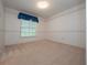 A cozy bedroom with patterned wallpaper and a window at 137 Hickory Ridge Cir, Lake Mary, FL 32746