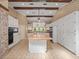 Bright kitchen with wood beam ceiling, a large island, and tile flooring at 137 Hickory Ridge Cir, Lake Mary, FL 32746