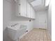 A clean laundry room featuring a utility sink and plenty of storage at 137 Hickory Ridge Cir, Lake Mary, FL 32746