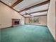 A spacious living room with exposed beams, a fireplace, and large windows at 137 Hickory Ridge Cir, Lake Mary, FL 32746