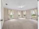 Spacious living room features plush carpeting, multiple windows and neutral paint at 137 Hickory Ridge Cir, Lake Mary, FL 32746