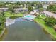 Great aerial view of a sparkling community pool and serene lake with lush green spaces and residential buildings at 14 Escondido Ct # 134, Altamonte Springs, FL 32701