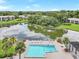 Breathtaking aerial view of a community pool and serene lake, surrounded by lush greenery and picturesque residential buildings at 14 Escondido Ct # 134, Altamonte Springs, FL 32701