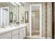 Bathroom with a vanity, large mirror, shower stall, and neutral color scheme at 14 Escondido Ct # 134, Altamonte Springs, FL 32701