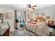 Cozy bedroom featuring a ceiling fan, neutral color palette, and ample natural light at 14 Escondido Ct # 134, Altamonte Springs, FL 32701