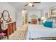 Spacious bedroom with a ceiling fan, ensuite bathroom, and large area rug at 14 Escondido Ct # 134, Altamonte Springs, FL 32701