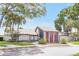 Exterior view of the community clubhouse, surrounded by landscaping and trees at 14 Escondido Ct # 134, Altamonte Springs, FL 32701