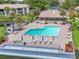Beautiful community pool with umbrellas, ample lounge chairs, and verdant landscaping perfect for relaxing in the sun at 14 Escondido Ct # 134, Altamonte Springs, FL 32701