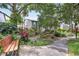 Serene community view with pond, mature trees, lush plants, and bench seating at 14 Escondido Ct # 134, Altamonte Springs, FL 32701