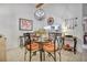 Bright dining room with a decorative chandelier, seating for four, and a pass-through to the kitchen at 14 Escondido Ct # 134, Altamonte Springs, FL 32701