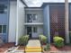 Inviting condo exterior featuring lush landscaping, fresh paint, and a decorative breezeway at 14 Escondido Ct # 134, Altamonte Springs, FL 32701