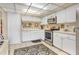 Well-lit kitchen featuring updated stainless steel appliances, white cabinets, and ample counter space at 14 Escondido Ct # 134, Altamonte Springs, FL 32701