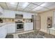 The kitchen has white cabinets, stainless steel appliances, and a black patterned rug at 14 Escondido Ct # 134, Altamonte Springs, FL 32701