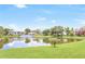 Scenic lake view with clubhouse in the background, surrounded by lush greenery at 14 Escondido Ct # 134, Altamonte Springs, FL 32701