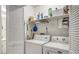 Bright laundry room featuring a washer, dryer, and shelving for storage at 14 Escondido Ct # 134, Altamonte Springs, FL 32701