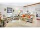 The view shows the living room, with lots of natural light, hardwood floors, and a comfy sofa at 14 Escondido Ct # 134, Altamonte Springs, FL 32701