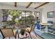 The screened in lanai features wood ceiling beams, a ceiling fan, and comfortable seating for four at 14 Escondido Ct # 134, Altamonte Springs, FL 32701