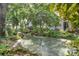 Picturesque community pond featuring a fountain, mature trees and plantings at 14 Escondido Ct # 134, Altamonte Springs, FL 32701