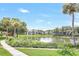 Scenic pond view with lush landscaping and tranquil waters in a serene community setting under a clear blue sky at 14 Escondido Ct # 134, Altamonte Springs, FL 32701