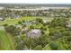 Aerial view of community amenities including pool, basketball, and tennis courts, nestled among lush greenery at 14474 Prunningwood Pl, Winter Garden, FL 34787