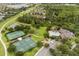 Aerial view showcasing the community's tennis courts, basketball court, swimming pool and playground at 14474 Prunningwood Pl, Winter Garden, FL 34787