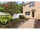 Well-maintained backyard featuring lush greenery, a paved walkway and privacy fence at 14474 Prunningwood Pl, Winter Garden, FL 34787