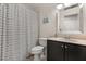Cozy bathroom features a shower/tub combo with a black and white striped curtain at 14474 Prunningwood Pl, Winter Garden, FL 34787