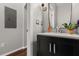 Half bathroom with a black vanity and dark wood floors at 14474 Prunningwood Pl, Winter Garden, FL 34787