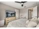 Comfortable bedroom with neutral walls, fan and a view into the hallway at 14474 Prunningwood Pl, Winter Garden, FL 34787
