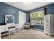 A blue bedroom that features a window view and a makeup vanity at 14474 Prunningwood Pl, Winter Garden, FL 34787