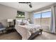A nicely lit bedroom featuring a large window and neutral tones at 14474 Prunningwood Pl, Winter Garden, FL 34787