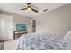 A bedroom with ceiling fan and a TV on a stand at 14474 Prunningwood Pl, Winter Garden, FL 34787
