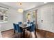 Bright dining room showcases a dark wood table with stylish blue chairs and natural light at 14474 Prunningwood Pl, Winter Garden, FL 34787