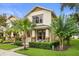 Charming two-story home with a beautifully landscaped front yard and inviting front porch seating area at 14474 Prunningwood Pl, Winter Garden, FL 34787