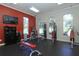 Modern fitness center featuring weight machines, free weights, and large windows for a bright and airy feel at 14474 Prunningwood Pl, Winter Garden, FL 34787