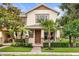 Inviting two-story home featuring a front porch, lush landscaping, and a charming brick walkway at 14474 Prunningwood Pl, Winter Garden, FL 34787