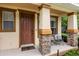 Charming front porch with seating area and decorative stone accents at 14474 Prunningwood Pl, Winter Garden, FL 34787