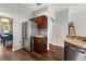 Kitchen features stainless steel refrigerator, and dark wood cabinets and countertops at 14474 Prunningwood Pl, Winter Garden, FL 34787
