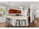 An open kitchen featuring wooden cabinets, stainless steel appliances, and bar seating at 14474 Prunningwood Pl, Winter Garden, FL 34787
