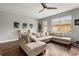 Spacious living room features a comfortable sectional sofa, wood flooring, and bright natural light at 14474 Prunningwood Pl, Winter Garden, FL 34787