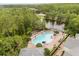 Aerial view of the community pool, lounging area and beautiful trees at 14474 Prunningwood Pl, Winter Garden, FL 34787
