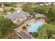 Aerial view of community pool area with lounge chairs and umbrellas at 14474 Prunningwood Pl, Winter Garden, FL 34787