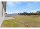 Spacious backyard with a concrete patio and white fencing, backing up to trees for privacy at 16730 Sw 50Th Cir, Ocala, FL 34473