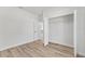 Sun-filled bedroom featuring ample closet space and wood-look flooring at 16730 Sw 50Th Cir, Ocala, FL 34473