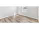 Light and airy bedroom with wood-look floors and a bright window at 16730 Sw 50Th Cir, Ocala, FL 34473