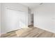 Bright bedroom features a closet with paneled doors and wood-look flooring at 16730 Sw 50Th Cir, Ocala, FL 34473