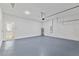 Spacious garage features painted floor, water heater, and an interior entry door at 16730 Sw 50Th Cir, Ocala, FL 34473