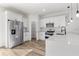Modern kitchen with stainless steel appliances, white cabinets, and a sleek countertop at 16730 Sw 50Th Cir, Ocala, FL 34473